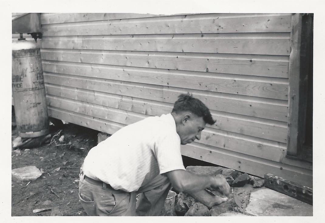 Careful work along the cottage foundation.